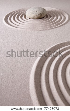 zen stone garden round stone and raked sand making line patterns tranquil scene for relaxation and meditation simplicity and balance are the base of a Japanese garden nice calm spa background