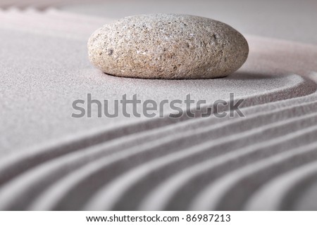 stone sand zen garden raked sand and pebble abstract for balance calmness spiritual and tranquil rippled pattern texture and lines background