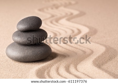 Balance of a pile or stack of stones in a Japanese zen meditation garden. Spa wellness hot stone therapy.