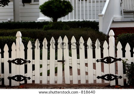 white picket fence in front of residence