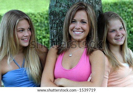 three beautiful girls hanging out in the park