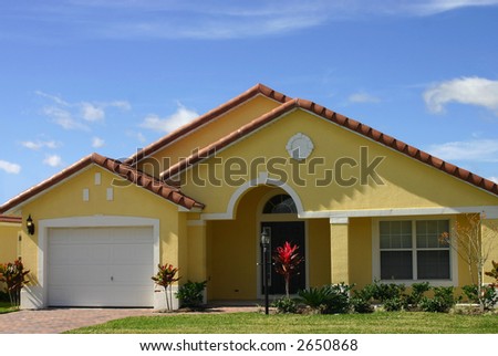 yellow american dream home against perfect blue sky