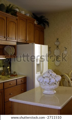modern american kitchen with center island and apple sculpture