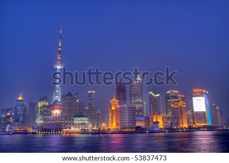SHANGHAI, PEOPLE\'S REPUBLIC OF CHINA - MAY 7: Shanghai skyline with the Pearl Tower lightened in the national colors during EXPO 2010 on May 7, 2010 in Shanghai, People\'s Republic of China.