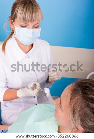 The reception was at the female dentist. Doctor examines the oral cavity on tooth decay.