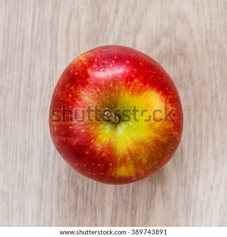 one red apple top view. wood background