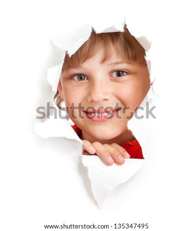 happy kid or child smiling face in torn paper hole isolated
