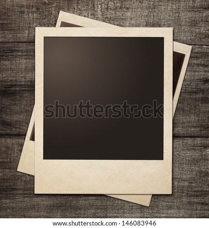 Polaroid Photo Frames On Wooden Grunge Background