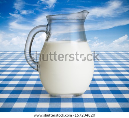 Milk jug on blue tablecloth