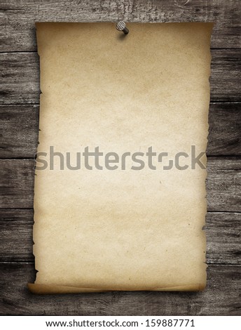 old wanted paper or parchment pinned by nail to grunge wooden background