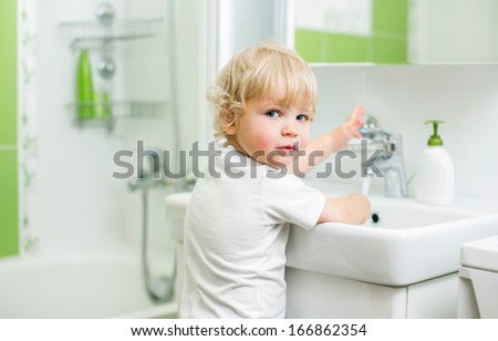 Kid Washing Hands In Bathroom