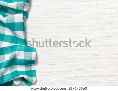 Folded Cyan Tablecloth On Bleached Wooden Table