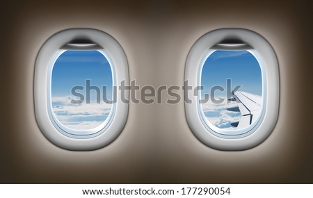 Two airplane windows. Jet interior.