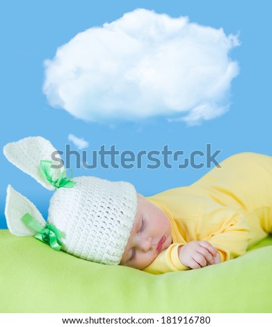 sleeping baby closeup portrait in hare or rabbit hat with dream cloud