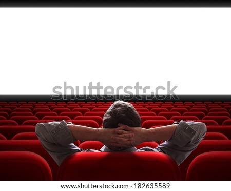 man sitting alone in empty cinema hall