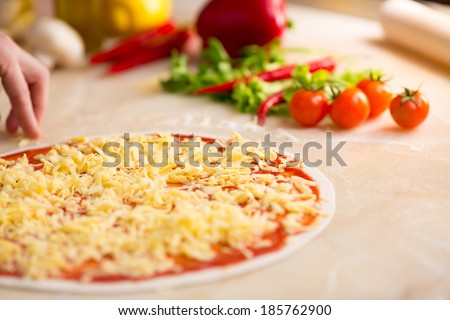 Italian pizza preparation. Cheese covering.