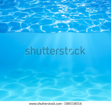 blue pool water surface and underwater with sun sparkles and beams
