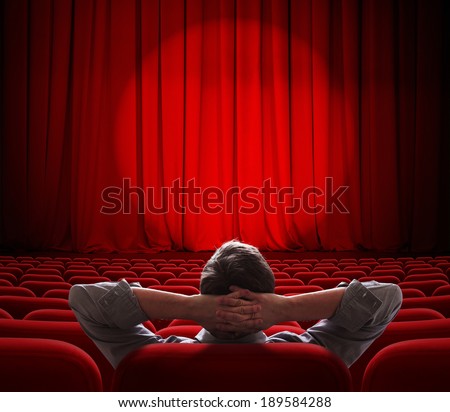man sitting alone in  empty theater or cinema hall