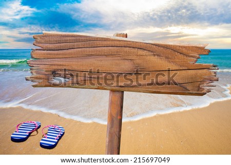 old wood sign on beach