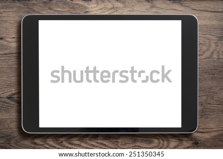 Black tablet pc that looks like ipad mini on old wood background