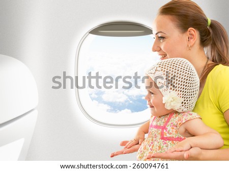Airplane flight from inside. Woman and kid travelling together.
