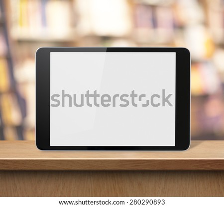 tablet PC on wood shelf in book shop or library