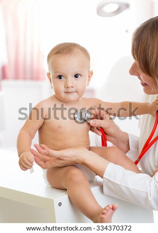 pediatrician doctor with quiet baby in medical room