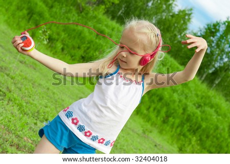 Blonde girl with closed eyes red earphones is listening mp3 player music and dancing