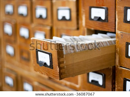Old wooden card catalog with one opened drawer