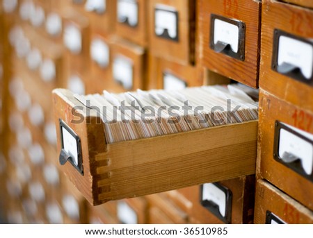 Old wooden card catalog with one opened drawer