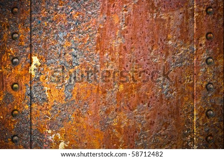 stock photo Rusty metal texture with rivets over red background
