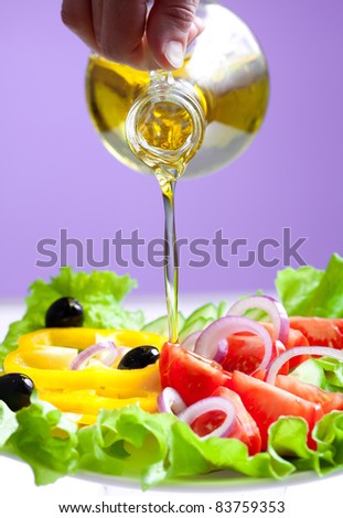 olive oil stream and healthy fresh vegetable salad