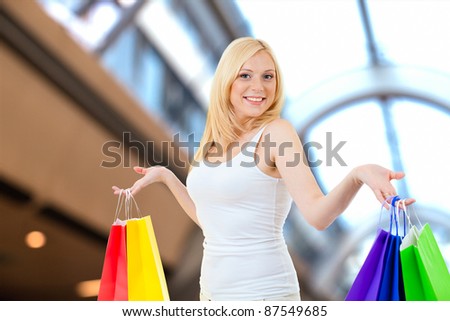 smiling women shopping with colored bags