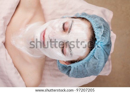 Beautiful woman with clear skin getting beauty treatment of her face at salon.  Clear Skin.