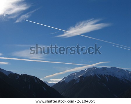 Aircraft vapor trails above Southern Alps New Zealand