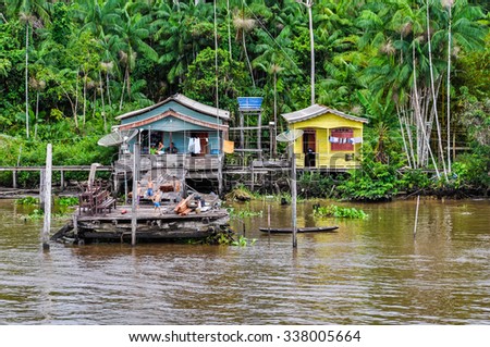 AMAZON RIVER, BRAZIL - MAY 11, 2012: Flooded local huts as seen from the boat on the Amazon River in Brazil.