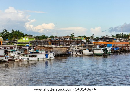 AMAZON RIVER, BRAZIL - MAY 12, 2012: Riverside village as seen from the boat on the Amazon River in Brazil.