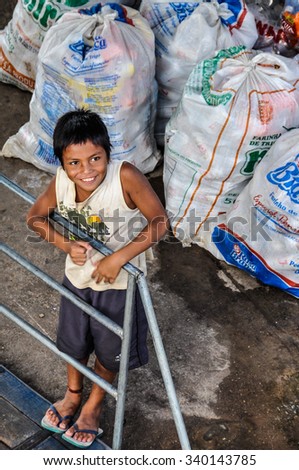 AMAZON RIVER, BRAZIL - MAY 12, 2012: Smiling boy as seen from the boat on the Amazon River in Brazil.
