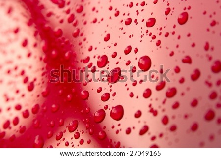 Detail of water drops on a red car after the rain