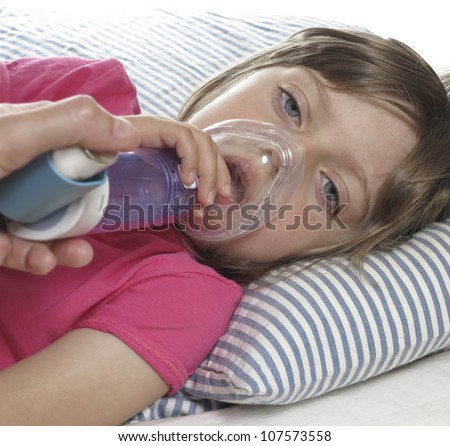 little girl with inhaler - respiratory problems for asthma