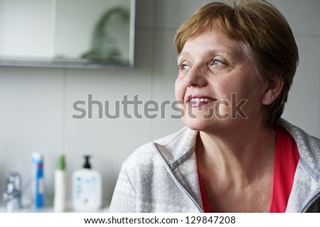 happy senior woman at home in the bathroom
