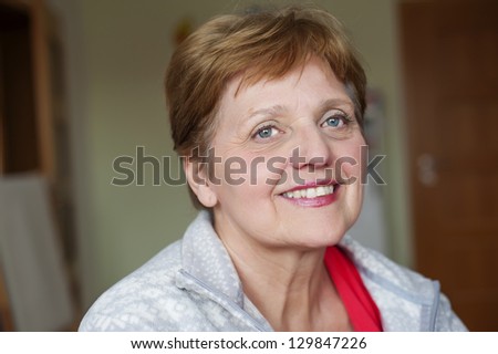 happy senior woman at home - bokeh background