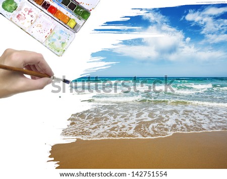 a hand painting a sea landscape