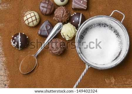 chocolate pralines and chocolate background
