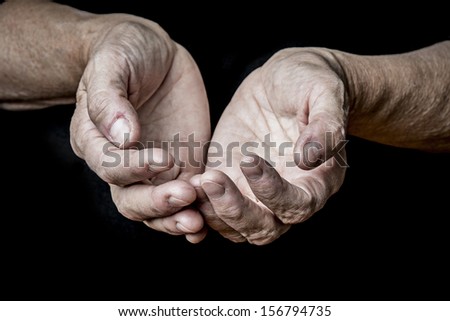 old elderly hands on a black background