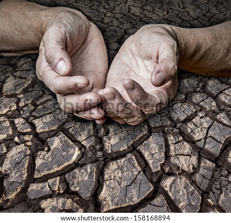 old elderly hands and dry earth