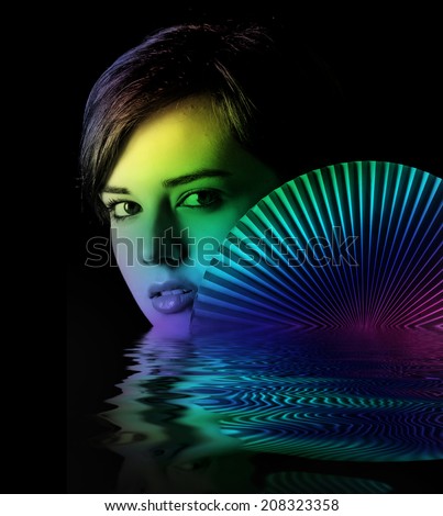 young woman with a fan on dark background