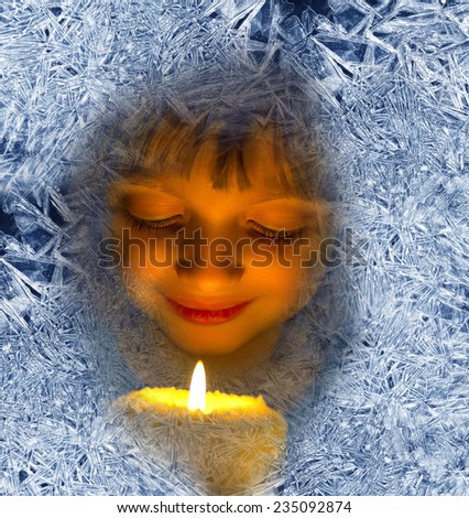 girl with candles looking through a frosted window