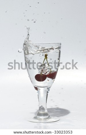 Glass with mineral water with cherry