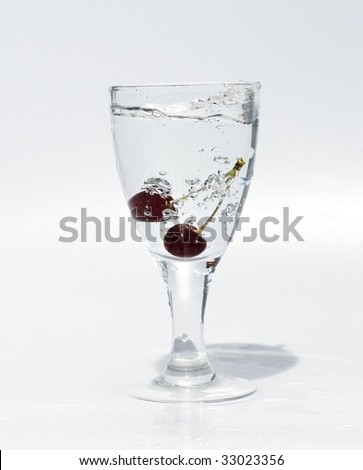 Glass with mineral water with cherries